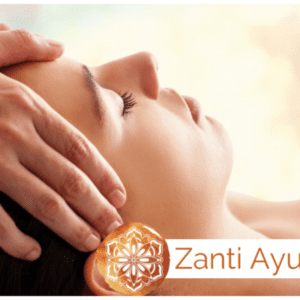 A woman receives an ayurvedic head massage from a masseuse.